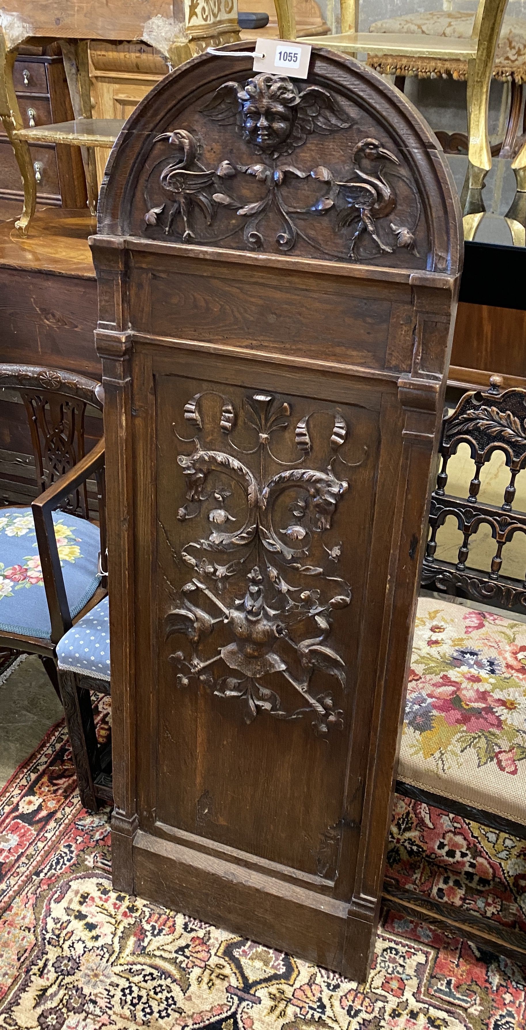 A 19th century carved oak plaque with cherub head pediment, width 50cm, height 145cm